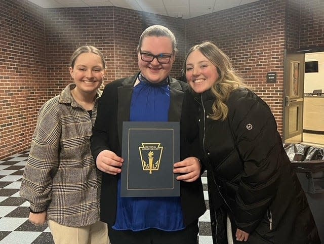 Taunton High School senior Madelyn Tokarz (center) is all smiles after being inducted into the National Honor Society which pleased her sister Kailyn (right) who plans to be a Special Education math teacher and their sister Jaclym (left) a junior student at Taunton High.