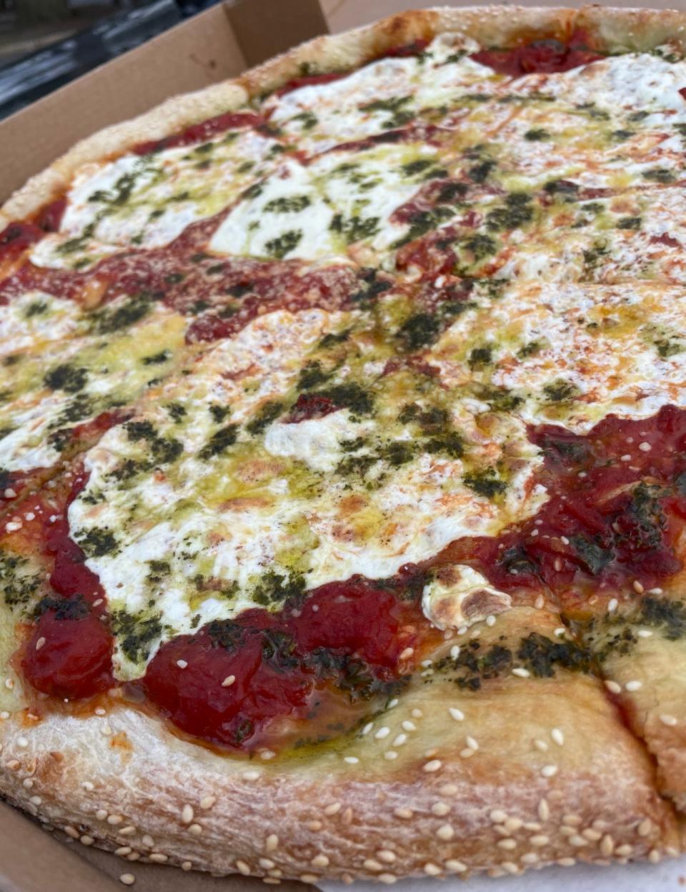 A signature sesame seed crust pizza with plum tomatoes, garlic, basil, fresh mozzarella and housemade pesto from Esposito's Pizza in Matawan and Manasquan.
