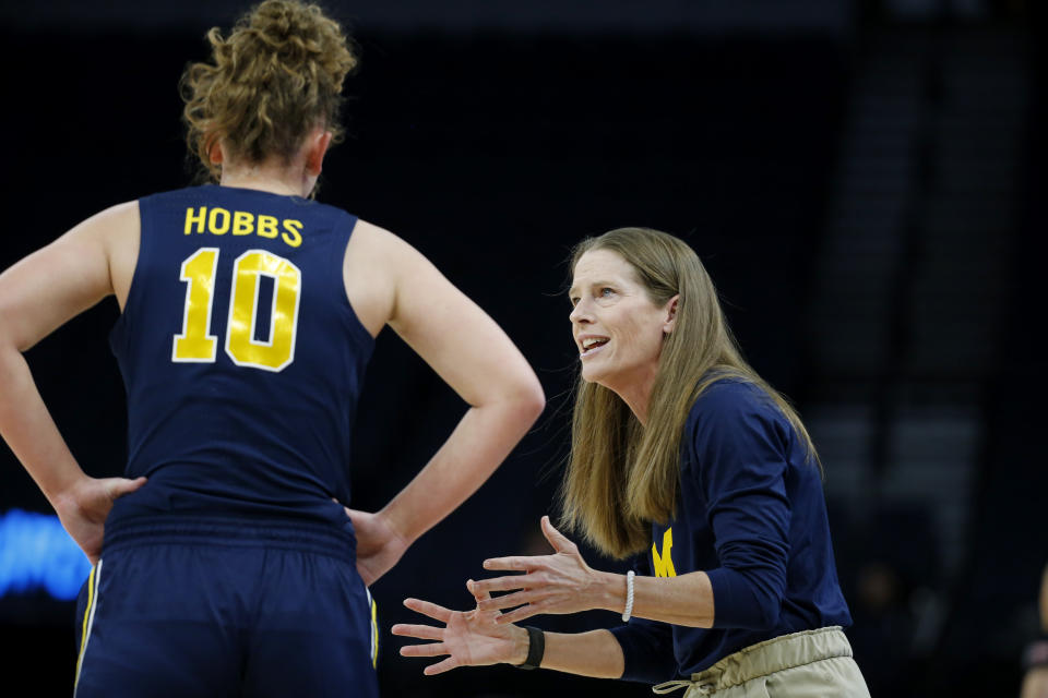 Michigan head coach Kim Barnes Arico, right, speaks with guard Jordan Hobbs (10) in the first half of an NCAA college basketball game against Ohio State at the Big Ten women's tournament Friday, March 3, 2023, in Minneapolis. (AP Photo/Bruce Kluckhohn)