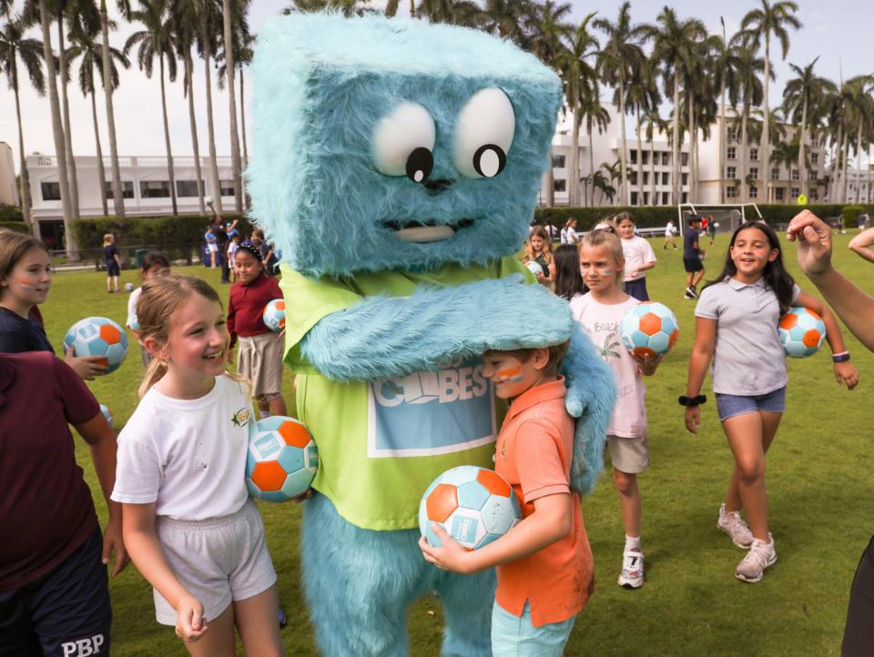 Cubi, the Energy Cubes Challenge mascot, surprises Palm Beach Public School students at the Mandel Recreation Center athletic field on Monday.