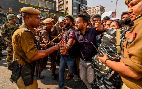 The north-eastern state of Assam witnessed the most violent protests with six people dying. It has now been placed under curfew - Credit: Biju Boro/AP