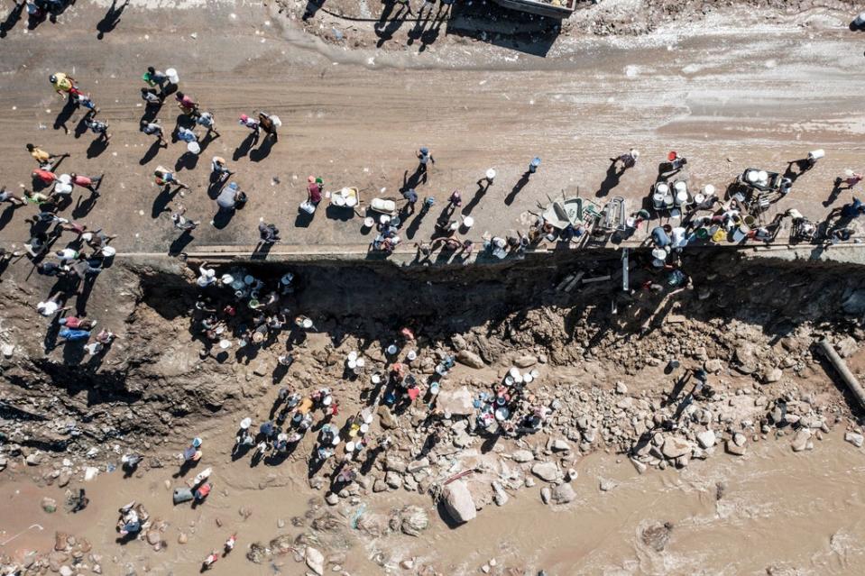 Residents of Amaoti, a township north of Durban, collect clean water from a broken pipe (AFP via Getty)