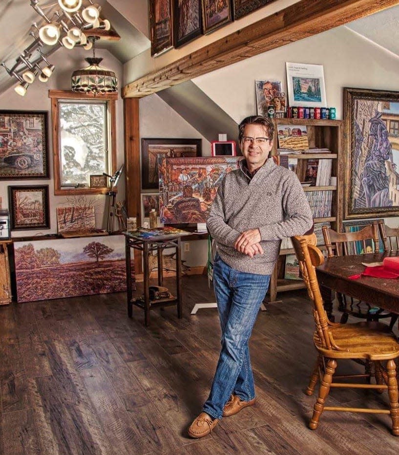 Artist Dan Rizzi poses in his studio.