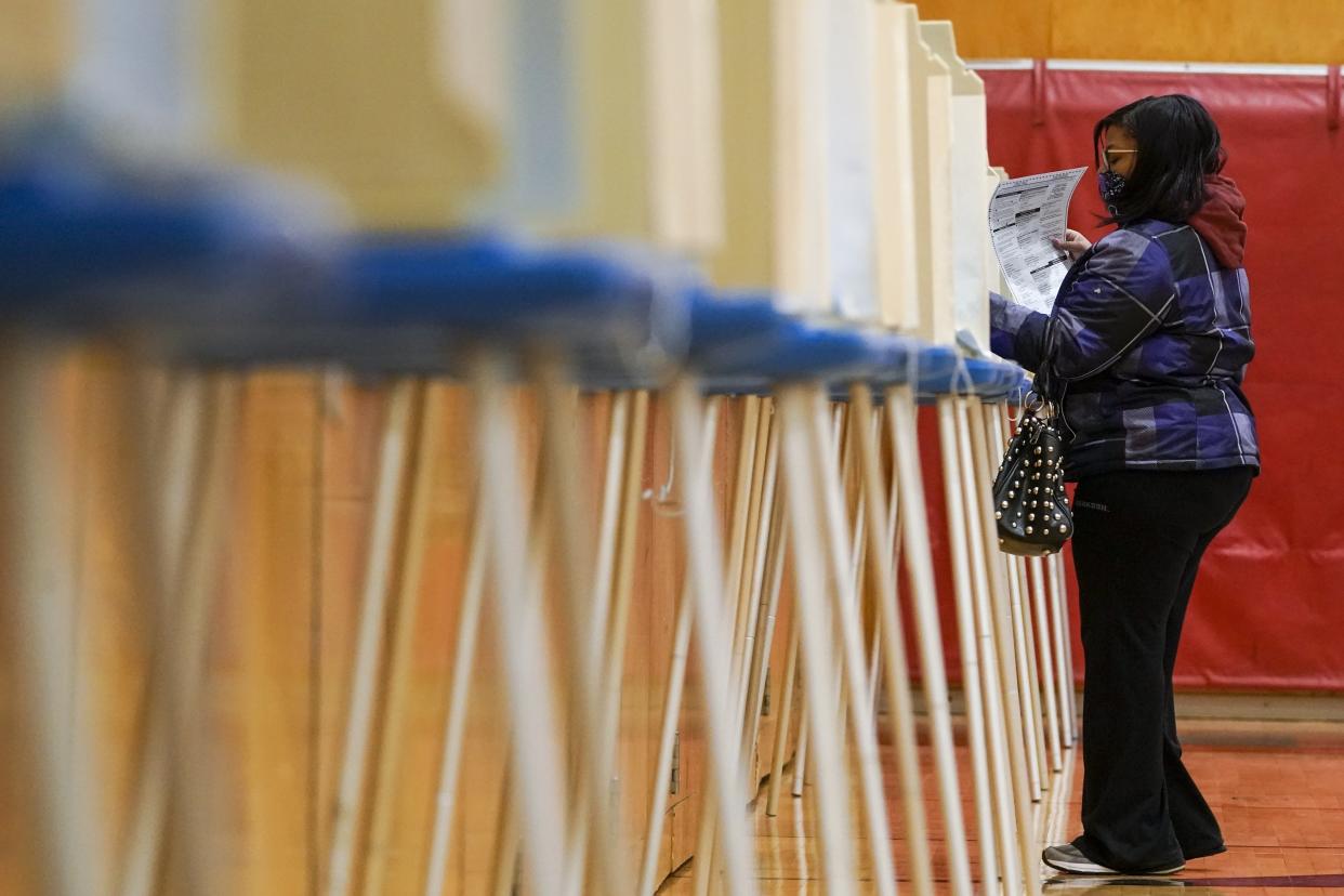 A voter casts her ballot on Election Day, on Nov. 3, 2020, at the Marshall High School in Milwaukee. (AP Photo/Morry Gash)