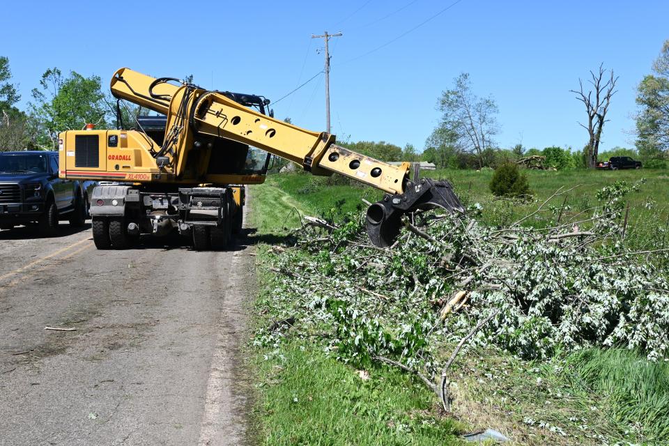 Branch County Road Commission pushes debris into piles alongside Arny Road.