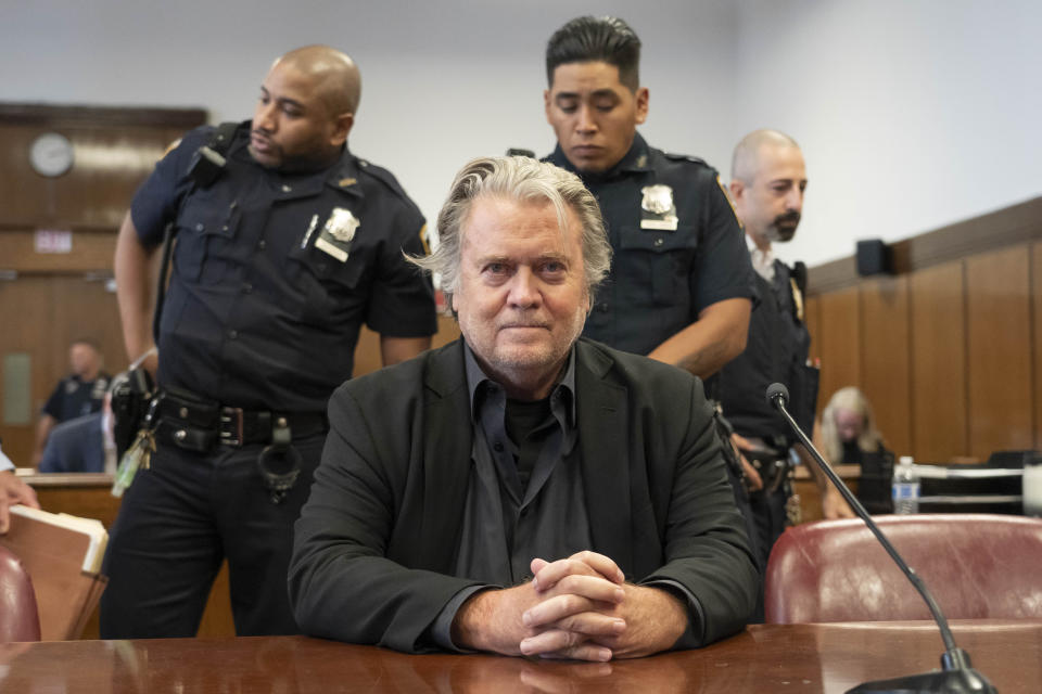 Steve Bannon sits in court with his hands clasped in front of him.