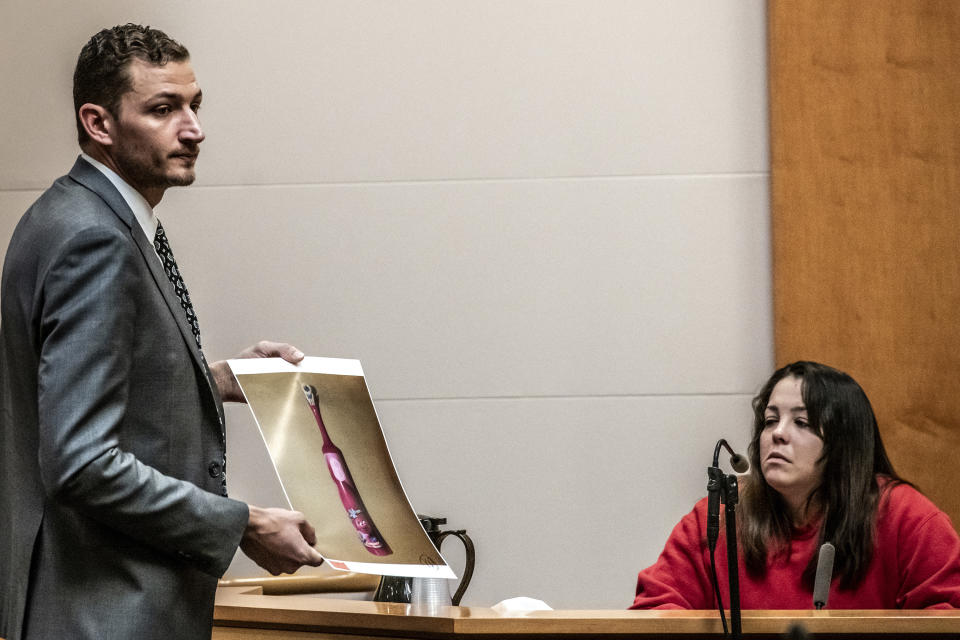 Prosecutor Christopher Knowles displays a toothbrush belonging to Harmony Montgomery as Kayla Montgomery testifies during the trial of Adam Montgomery at Hillsborough County Superior Court in Manchester, N.H, on Friday, Feb. 9, 2024. Adam Montgomery is accused of killing his 5-year-old daughter and spending months moving her body before disposing of it. (Jeffrey Hastings/Pool Photo via AP)