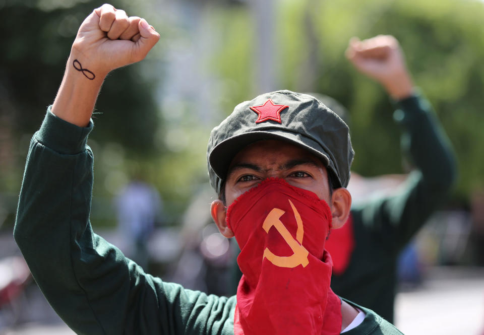 <p>A Filipino activist uses a cloth printed with the hammer and sickle symbol to cover his face during a rally near the Malacanang presidential palace in Manila, Philippines Monday, Aug. 22, 2016. Philippine President Rodrigo Duterte recently reimposed an indefinite cease-fire after communist guerrillas declared their own truce as both sides resume talks aimed at ending one of Asia’s longest-running rebellions. (AP Photo/Aaron Favila) </p>