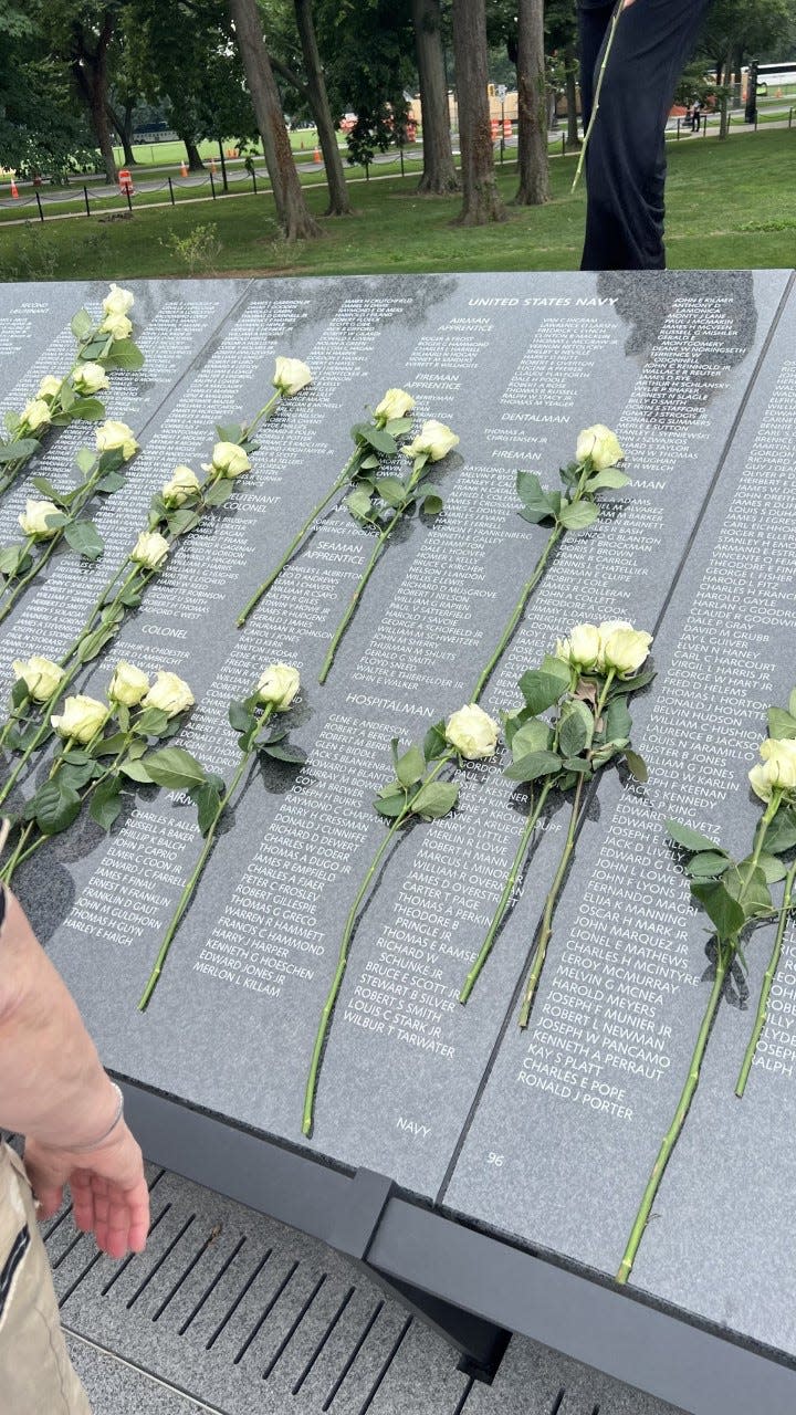 Yellow roses placed around the names of those lost in the Korean War at the Wall of Remembrance dedication in Arlington, Virginia.