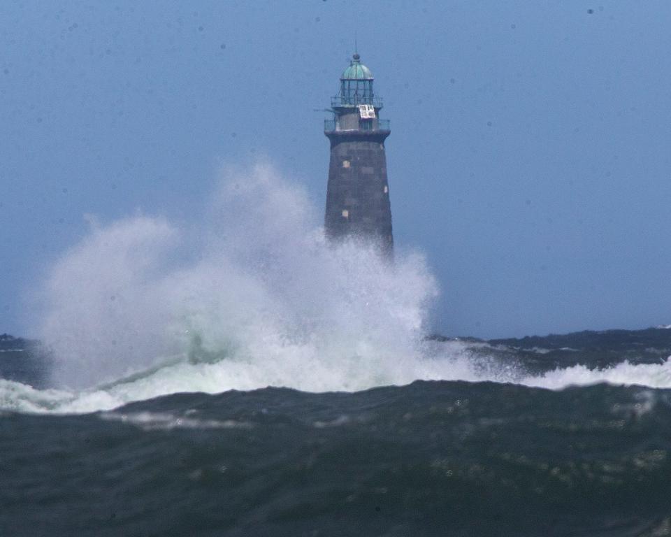 Waves crash in front of Minot Lighthouse off the coast of Minot Beach in Scituate at high tide as the early front of Hurricane Lee brings strong winds to the area on Friday, Sept. 15, 2023.