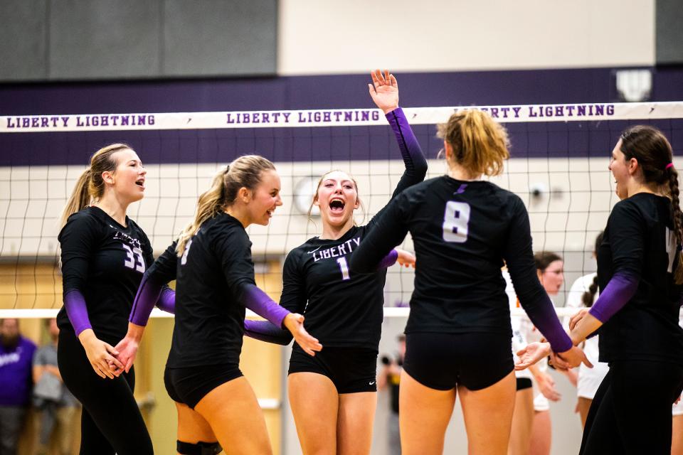 Iowa City Liberty's Gracie Hennings (1) celebrates a point with teammates during a Class 5A regional final victory against Cedar Rapids Prairie on Oct. 25 in North Liberty.