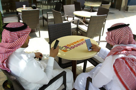 Saudi men explore social media on their mobile devices as they sit at a cafe in Riyadh, Saudi Arabia May 24, 2016. REUTERS/Faisal Al Nasser