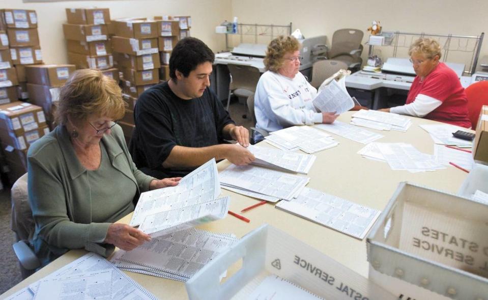 Temporary election workers hand count a precinct to verify the machine vote count. From the left: Sandy Madison, Aramis Ramos, Minerva Holden and Merodie Nelson (cq) work at the County Government Center on Nov. 16, 2012