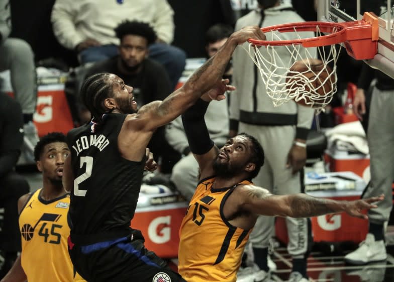 Los Angeles, CA, Monday, June 14, 2021 - LA Clippers forward Kawhi Leonard (2) slam dunks over Utah Jazz center Derrick Favors (15) late in the first half in game four of the NBA Western Conference semifinals at Staples Center (Robert Gauthier/Los Angeles Times)