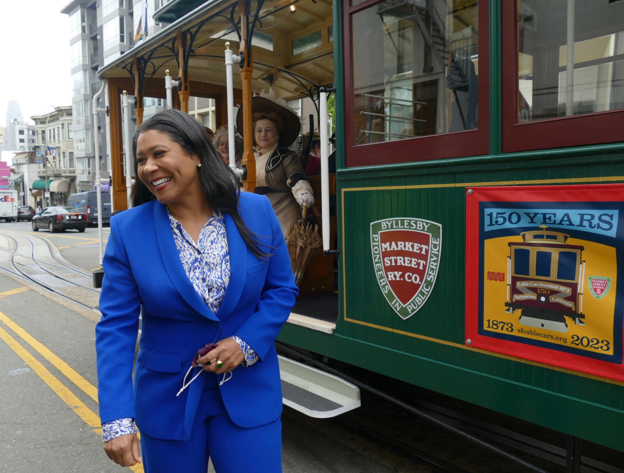 San Francisco Mayor London Breed stands in front of the historic cable car.