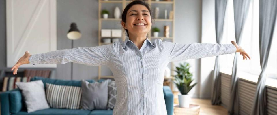 Lively Indian girl having wide smile standing with