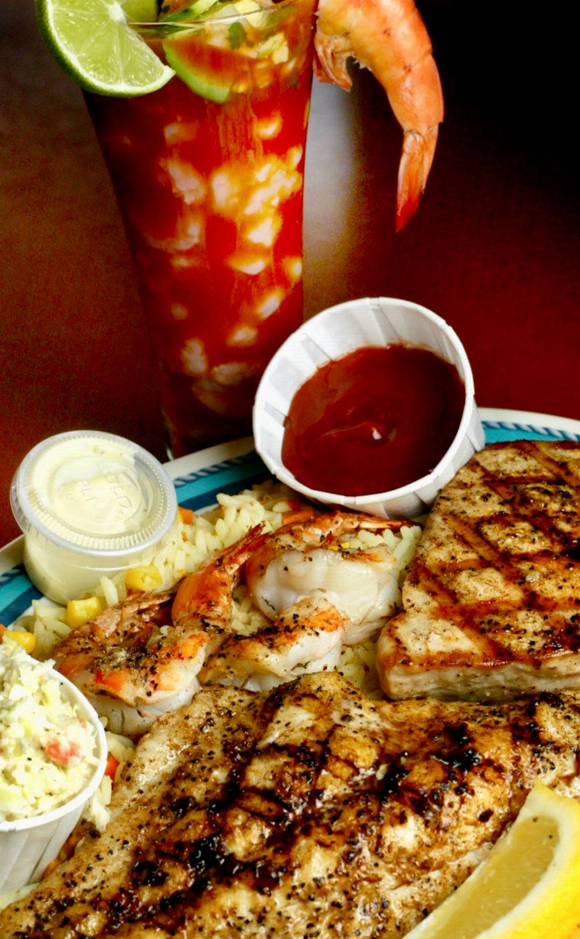 A seafood cocktail and a grilled seafood combo platter at J&J Oyster Bar.