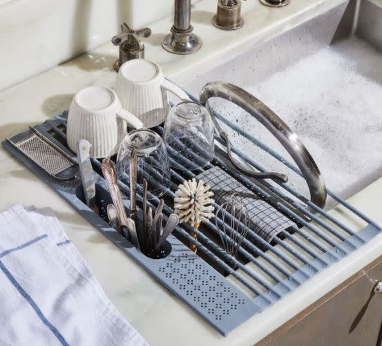 Find this <a href="https://fave.co/2EKrgkm" target="_blank" rel="noopener noreferrer">Five Two Over-the-Sink Drying Rack for $45</a> with slots for utensils, plates and more at Food52.