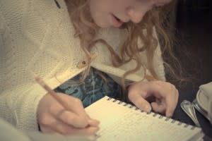 girl writing in journal