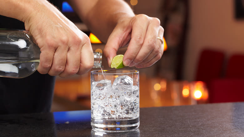 person making vodka cocktail