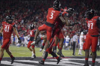 Cincinnati defensive lineman Jabari Taylor, center right, celebrates with teammates after recovering a fumble in the end zone during the second half of an NCAA college football game against Tulsa Saturday, Nov. 6, 2021, in Cincinnati. (AP Photo/Jeff Dean)