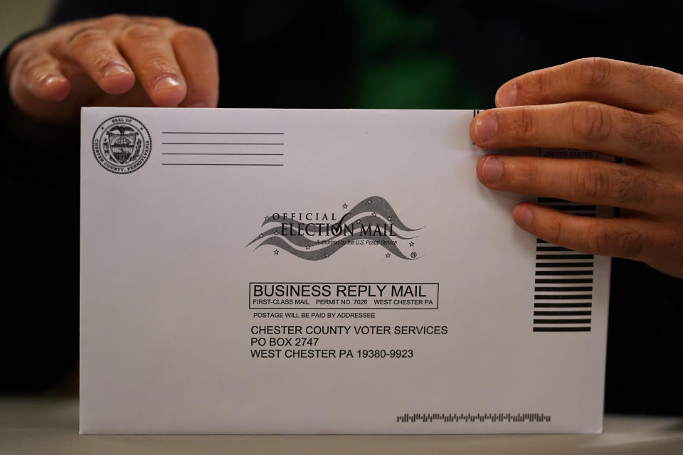 A Chester County election worker processes ballots for the Pennsylvania primary election at the Chester County Voter Services office, Thursday, May 19, 2022, in West Chester, Pa. (AP Photo/Matt Slocum)