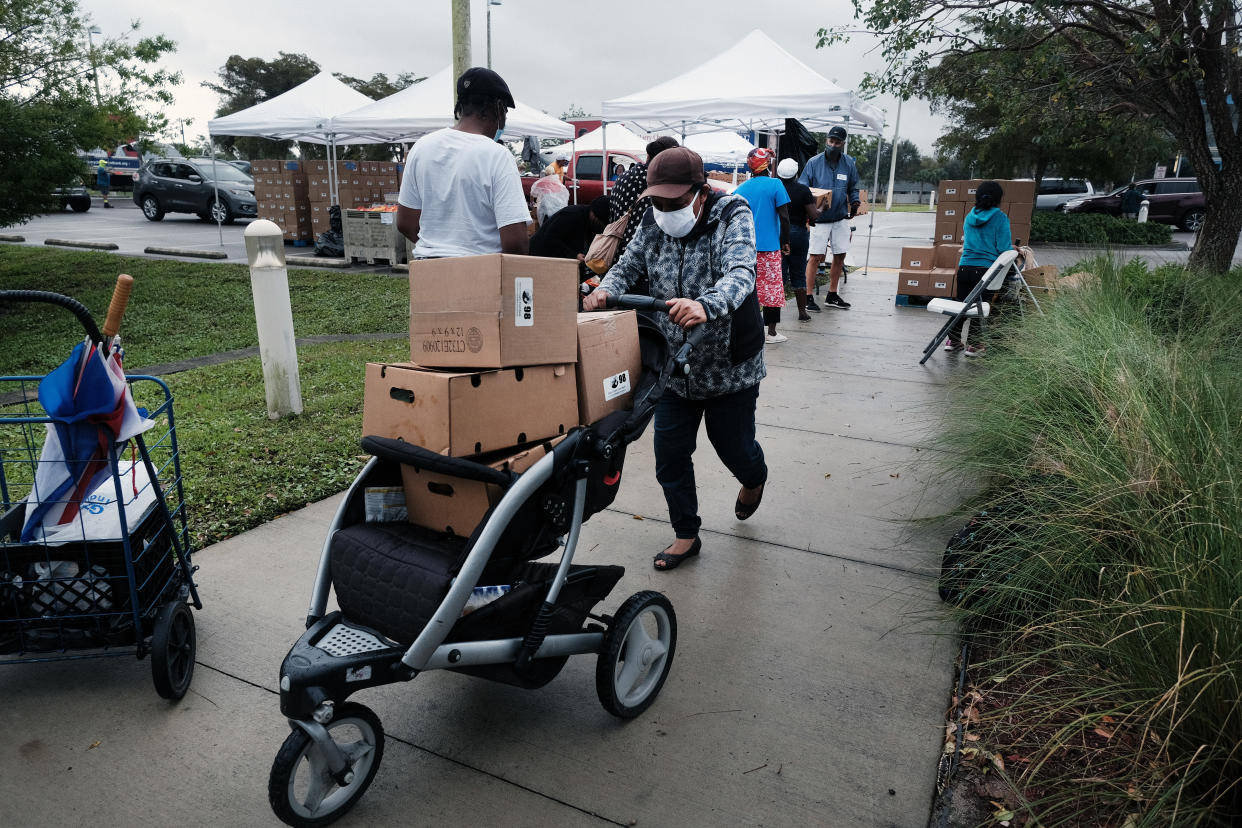 IMMOKALEE, FLORIDA - FEBRUARY 16: Food is distributed during a mobile food pantry in the agricultural community of Immokalee on February 16, 2021 in Immokalee, Florida. The Harry Chapin Food Bank has weekly distributions in the town which has a poverty rate of over 40% and has a population made up primarily of agricultural workers. The mobile food pantry gives out food packages for over 800 families after seeing a surge in need since the Covid-19 outbreak. (Photo by Spencer Platt/Getty Images)