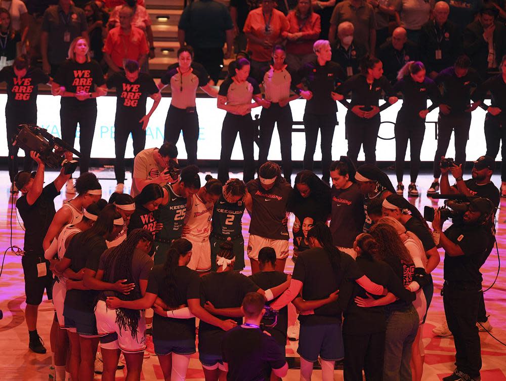 Players with the Connecticut Sun and Phoenix Mercury link arms for 42 seconds in honor of Phoenix Mercury center Brittney Griner before a WNBA basketball game Thursday, Aug. 4, 2022, in Uncasville, Conn. (Sarah Gordon/The Day via AP)