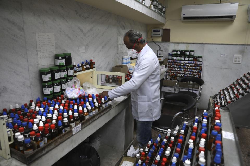 A doctor makes homeopathic pills in New Delhi, India.