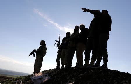 FILE PHOTO: Turkish-backed Syrian rebels stand with their weapons at Manbij countryside, Syria December 29, 2018. REUTERS/Khalil Ashawi/File Photo