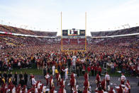 Iowa State fans celebrate on the field after an NCAA college football game against Oklahoma State, Saturday, Oct. 23, 2021, in Ames, Iowa. Iowa State won 24-21. (AP Photo/Charlie Neibergall)