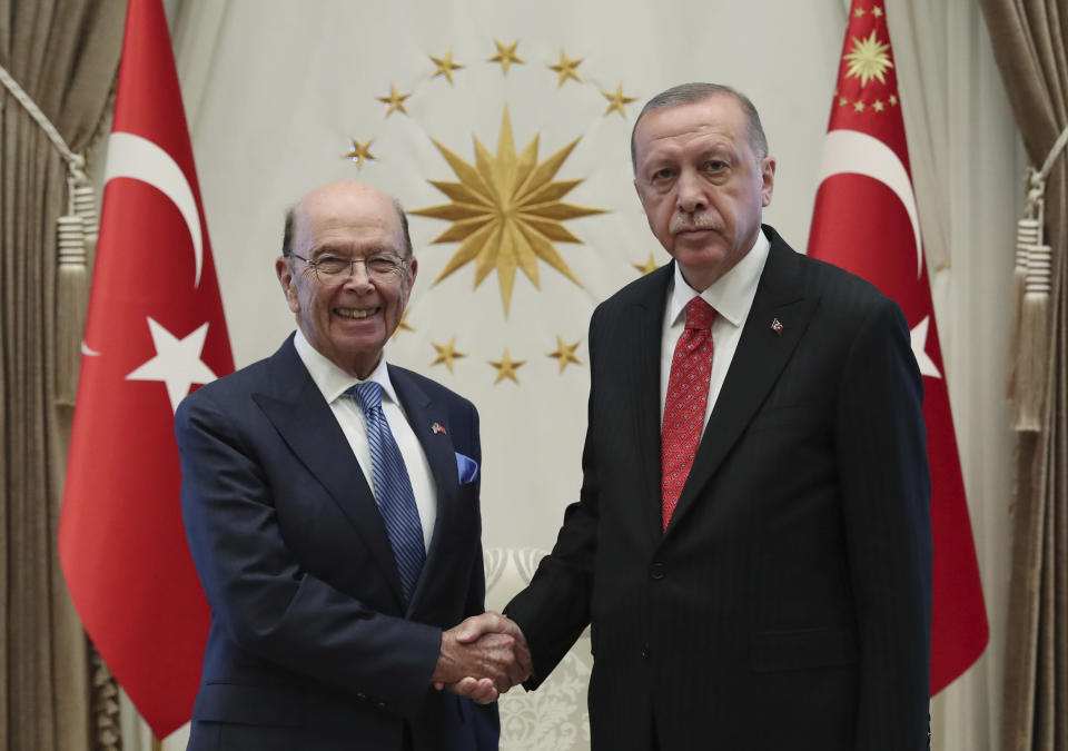 Turkey's President Recep Tayyip Erdogan, right, shake hands with U.S. Commerce Secretary Wilbur Ross at his palace, in Ankara, Turkey, Tuesday, Sept. 10, 2019. Turkey accused the United States on Tuesday of taking only "cosmetic steps" toward the creation of a so-called "safe zone" in northeast Syria and renewed Ankara's threat of unilateral military intervention to form a buffer area along its border.(Presidential Press Service via AP, Pool)