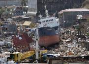 A cargo ship washed ashore is seen four days after super typhoon Haiyan hit Anibong town, Tacloban city, central Philippines November 11, 2013.