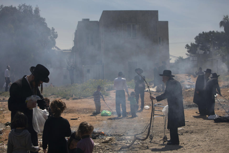 Ultra-Orthodox Jewish men burn leavened items in final preparation for the Passover holiday in the ultra-Orthodox Jewish town of Bnei Brak, near Tel Aviv, Israel, Monday, April 14, 2014. Jews are forbidden to eat leavened foodstuffs during the Passover holiday that celebrates the biblical story of the Israelites' escape from slavery and exodus from Egypt. (AP Photo/Oded Balilty)