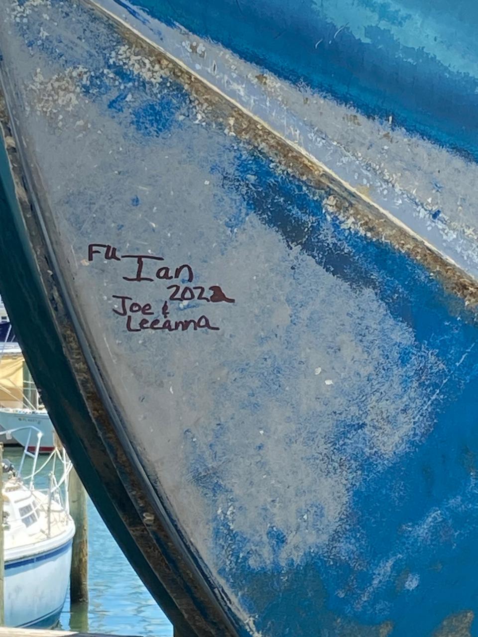 Someone recently scribbled some graffiti on the "Batchelor Pad", a 42-foot, 20-ton yacht that was pushed into the dock at Bonita Bill's near Fort Myers Beach by Hurricane Ian.