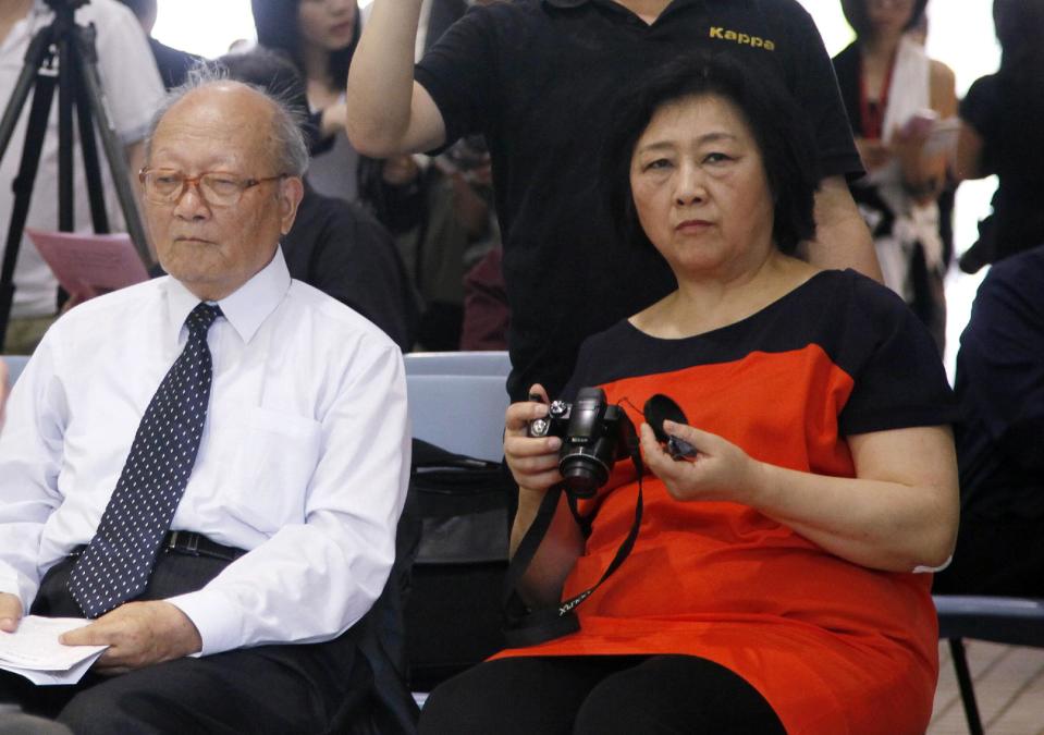 In this June 9, 2012 photo, Chinese journalist Gao Yu, right, who was imprisoned for nearly 6 year in the 1990s on charges of leaking state secrets, holds a camera besides Chinese author Yao Jianfu, left, during an opening ceremony of Chinese artist Liu Xia's photo exhibition in Hong Kong. Prominent Chinese journalist Gao Yu has been "criminally detained" just weeks ahead of the 25th anniversary of the Tiananmen Square crackdown for allegedly leaking state secrets to a foreign news site, the state news agency Xinhua reported Thursday, May 8, 2014. (AP Photo/Kin Cheung)