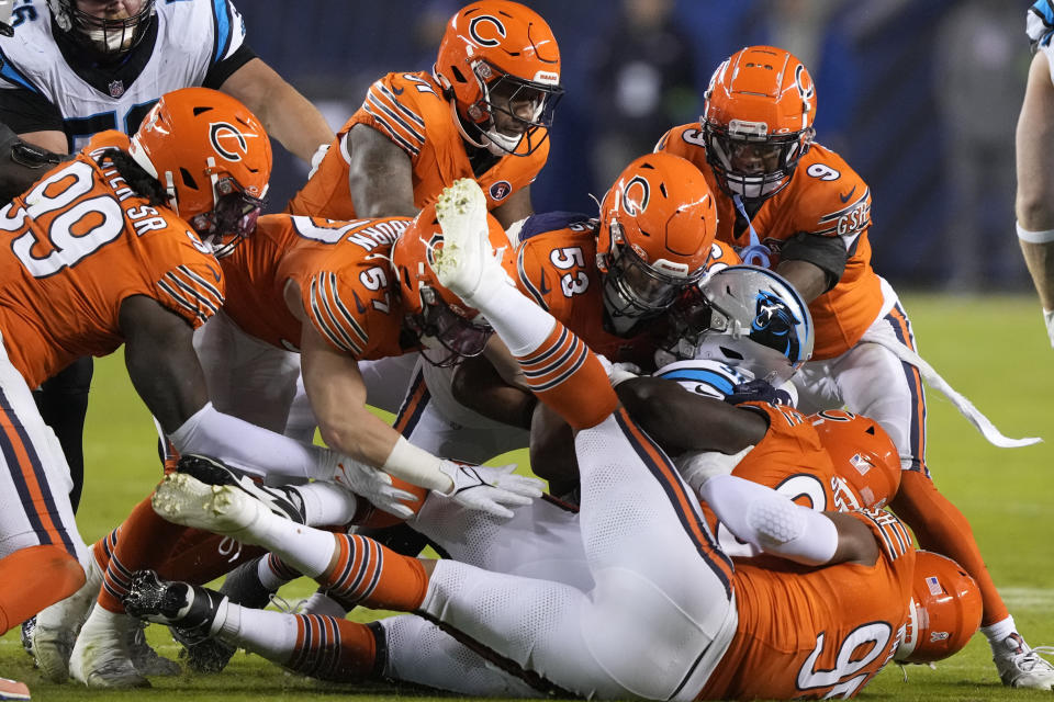 Carolina Panthers running back Chuba Hubbard is tackled by a group of Chicago Bears defenders during the second half of an NFL football game Thursday, Nov. 9, 2023, in Chicago. (AP Photo/Charles Rex Arbogast)