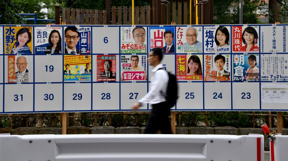 A pedestrian walks in front of the upper house election posters in Tokyo on July 20, 2019, one day before the voting starts. (Photo by Toshifumi KITAMURA / AFP)        (Photo credit should read TOSHIFUMI KITAMURA/AFP/Getty Images)