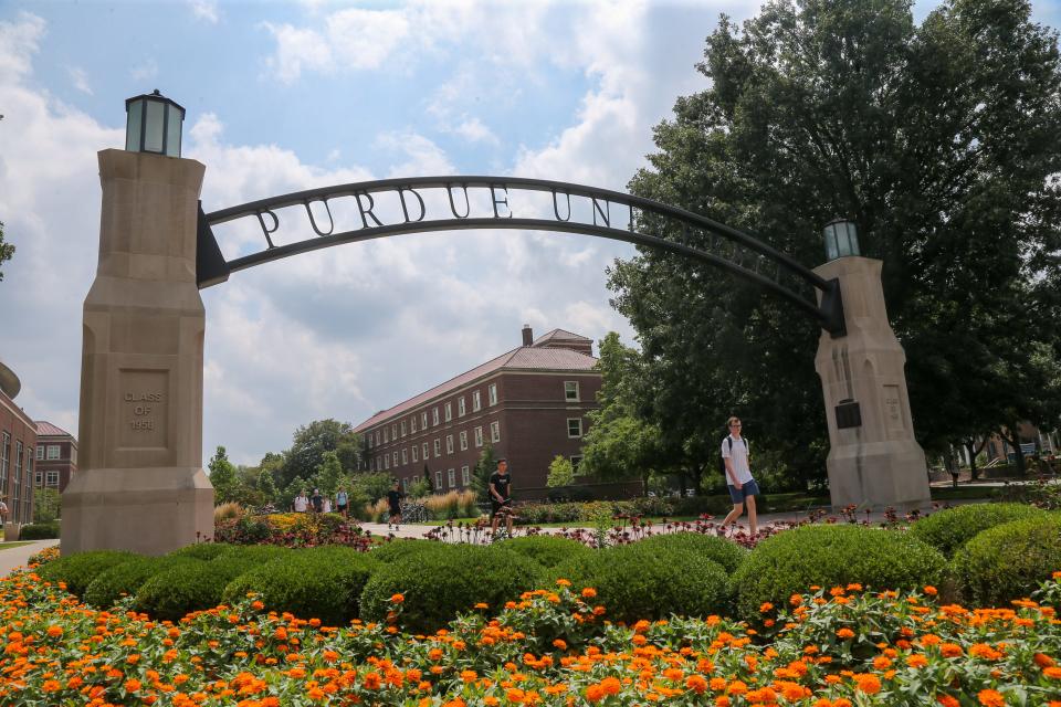 Students walk through Purdue University's archway on the first day of the 2023-2024 academic school year, on Monday, Aug. 21, 2023.