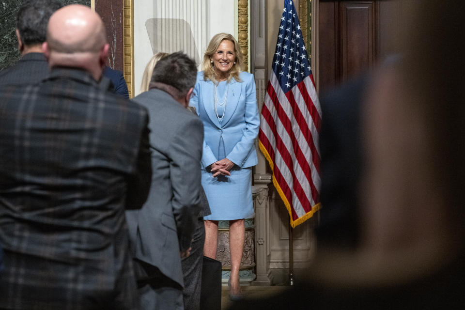 People stand for first lady Jill Biden as she arrives to speak during a White House Office of Gun Violence Prevention event with K-12 principals in the Eisenhower Executive Office Building, Thursday, Jan. 25, 2024, on the White House complex in Washington. (AP Photo/Jacquelyn Martin)