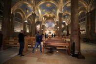 A man inspects the damaged floor after a man tried to set fire to the Church of All Nations next to the Garden of Gethsemane in Jerusalem