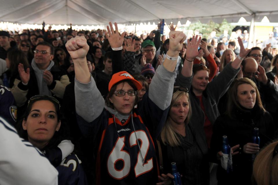 An audience cheers for the B Street Band at the Meadowlands Tailgate Party 2014 along Park Avenue in East Rutherford before the start of Super Bowl XLVIII.