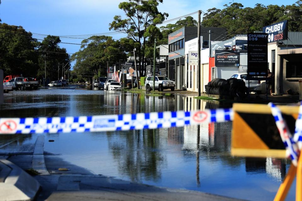A flooded road is seen in the Sydney suburb of North Narrabeen on 6 April 2024, after heavy rain hit New South Wales state (AFP via Getty Images)