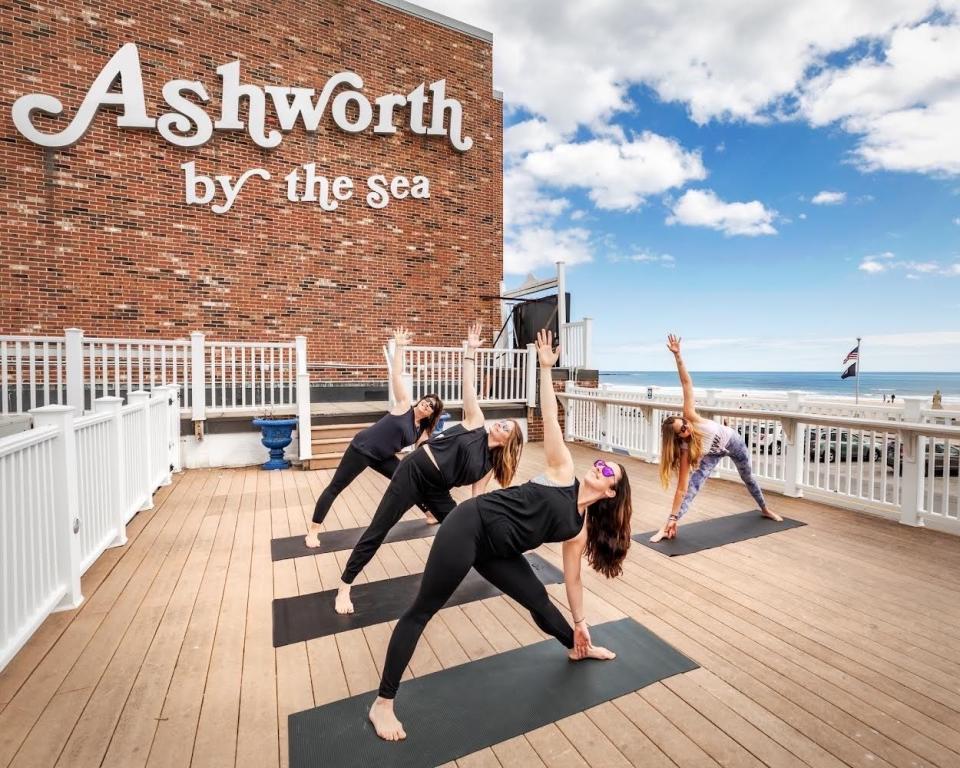 Hampton Beach Yoga and Mindfulness owners Rianna Cordes and Susan Bezreh offer their skills as yoga instructors at the deck at Ashworth by the Sea, overlooking the beach.