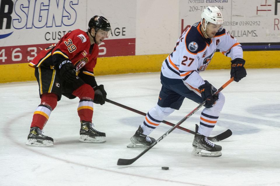 Stockton Heat's Luke Philp, left, tries to steal the puck from Bakersfield Condors' Adam Cracknell during the second game of the Calder Cup playoffs.