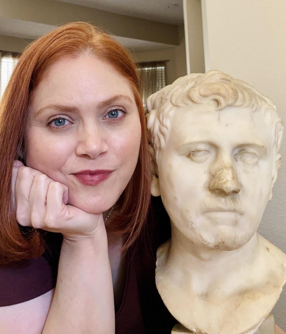 Laura Young poses with the bust she bought in 2018. The Roman artifact will be on display at SAMA for about a year, starting May 4, 2022. / Credit: SAMA