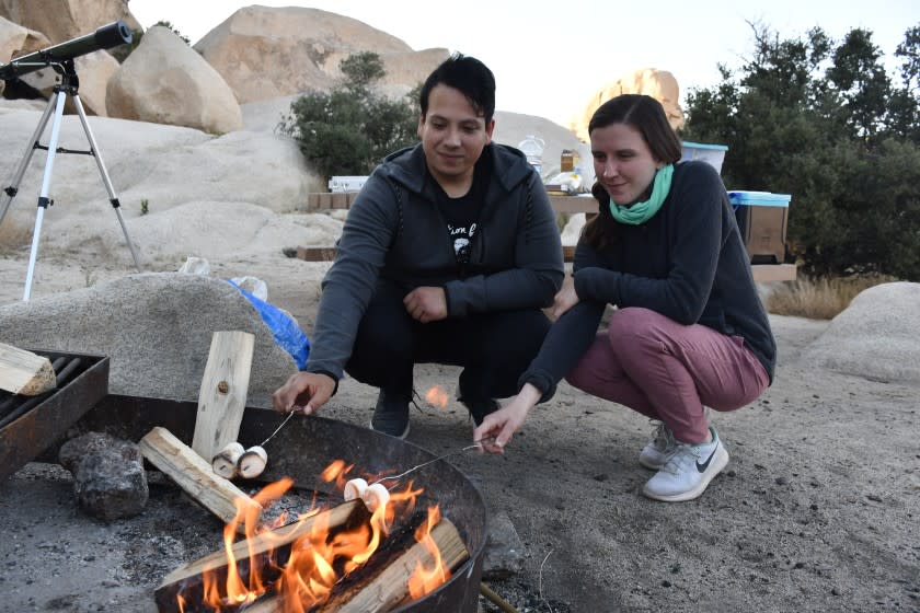 Campers Holly Hirschi and Edgar Carrillo roast mashmallows May 20 at Hidden Valley campground in Joshua Tree National Park.