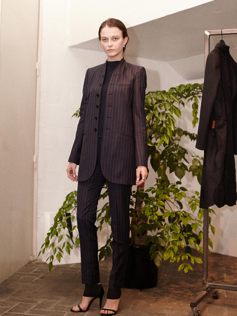 A model wears a Coperni Femme pinstripe suit.