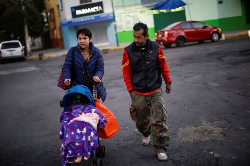 Esperanza Paz pushes the trolley with her son, Hermes Soto, as she walks together with Hermes' dad, Armando Soto, on their way to the hospital in Mexico City