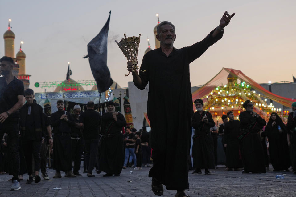 Shiite Muslim worshippers gather to grieve for Imam Hussein, on the 9th day of Muharram, outside the golden-domed shrine of Imam Moussa al-Kadhim in Baghdad, Iraq, Friday, July 28, 2023. During Muharram, Islam's second holiest month, Shiites mark the death of Hussein, the grandson of the Prophet Muhammad, at the Battle of Karbala in present-day Iraq in the 7th century. (AP Photo/Hadi Mizban)